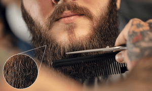 man-looking-at-split-ends-in-his-beard