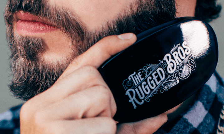 man-brushing-his-beard